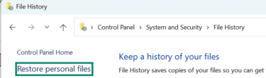 The File History window of the Windows Control Panel is open, and Restore personal files is highlighted.